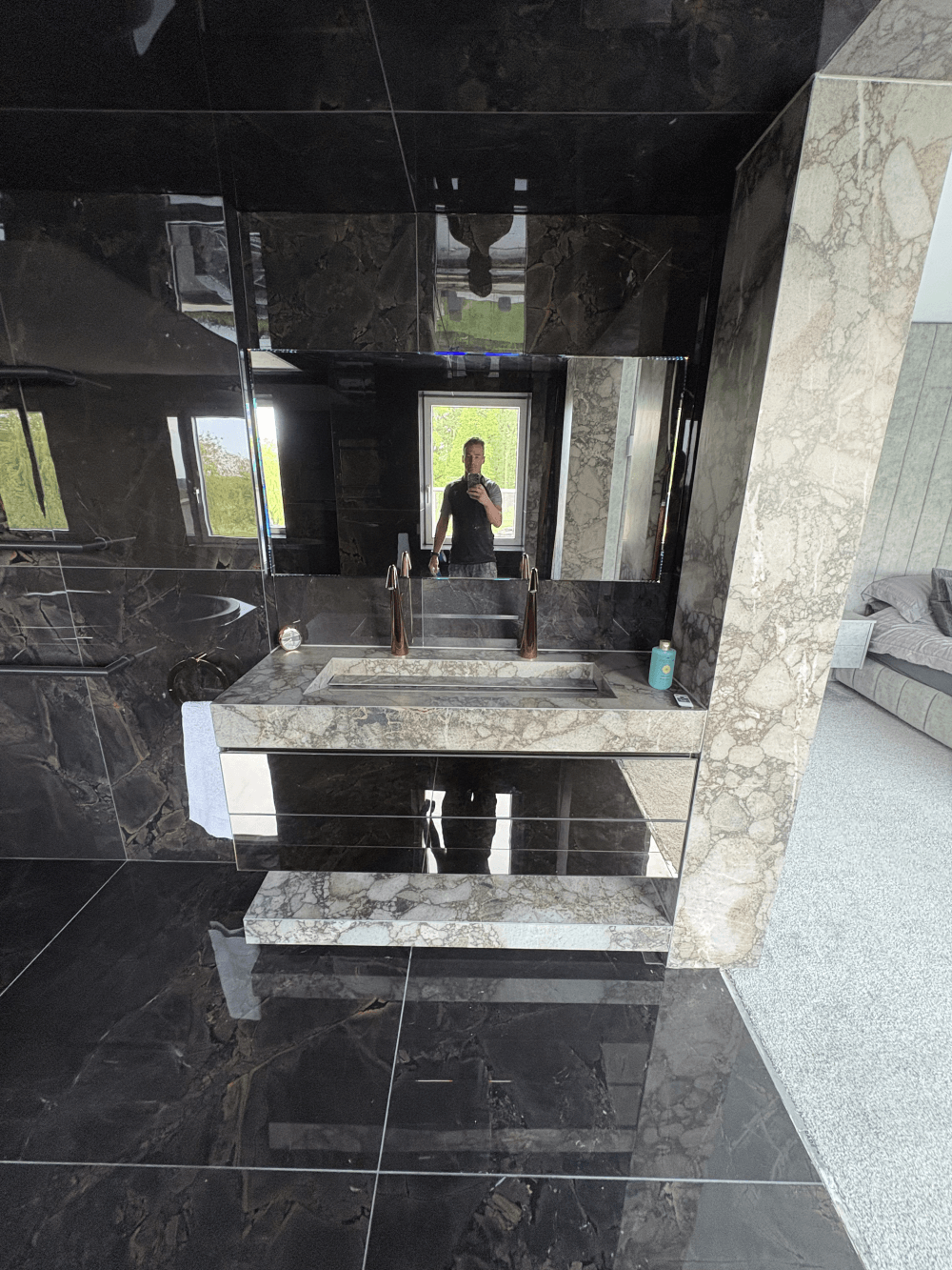 Book-matched stone vanity and mirror with copper tapware